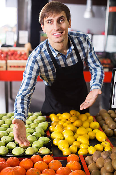 istock Grocery worker selling seasonal fruits 537450910