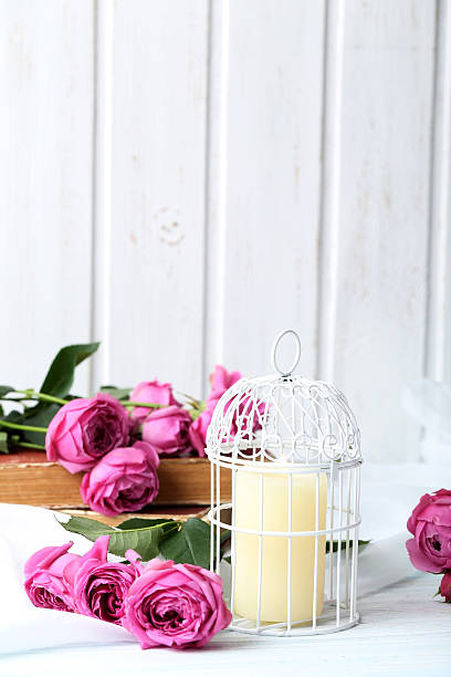 istock Beautiful pink roses on a white wooden table 537451474