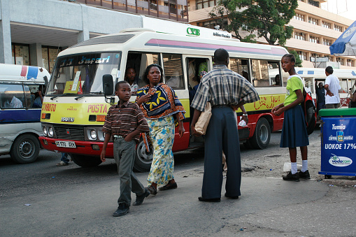 Dar es Salaam, Tanzania - February 21, 2008: Passengers expect public transportation to the bus stop.