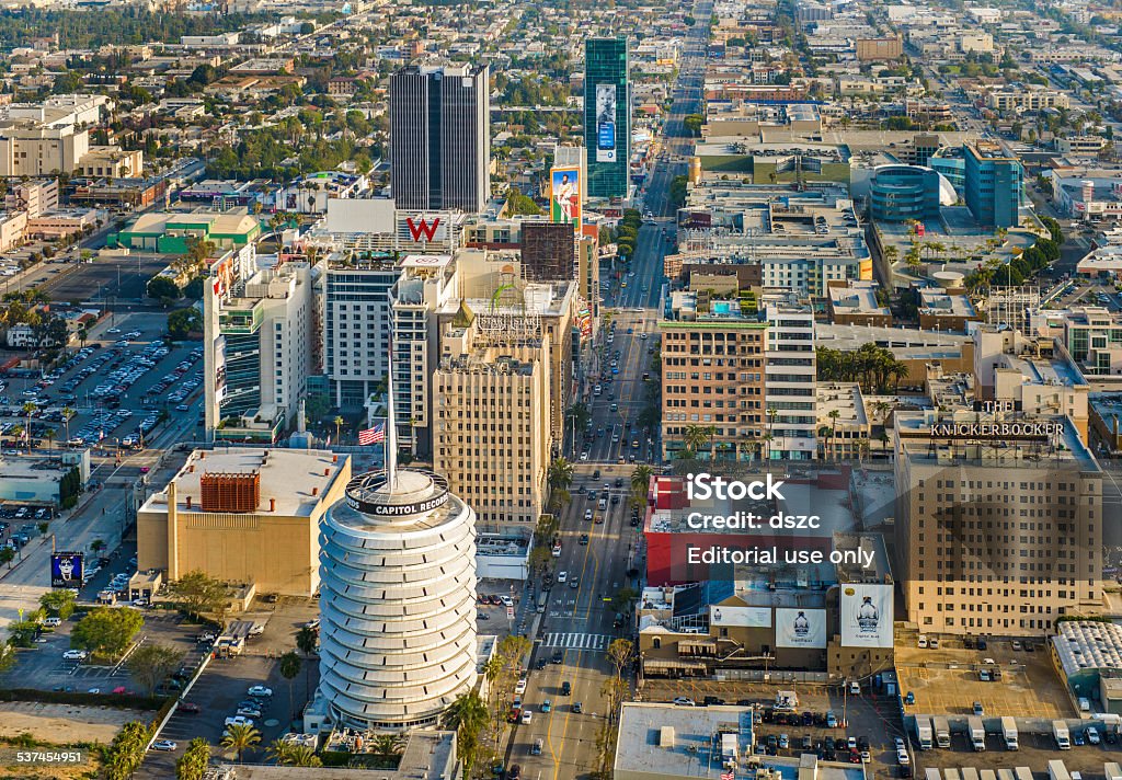 City of Los Angeles, Downtown Hollywood California - aerial view Los Angeles, USA - April 29, 2012: Aerial view from helicopter of downtown Hollywood District in Los Angeles, California. The round light-colored building in the bottom-left foreground is the iconic Capitol Records tower. Capitol Records Building Stock Photo