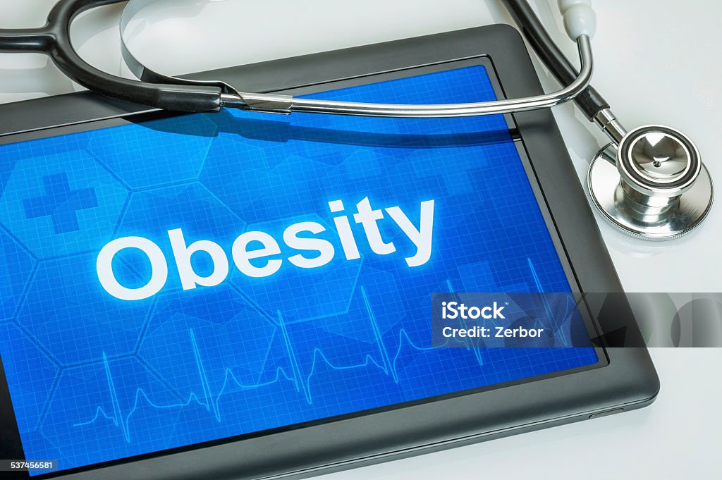 Tablet with the diagnosis obesity on the display Obesity Stock Photo