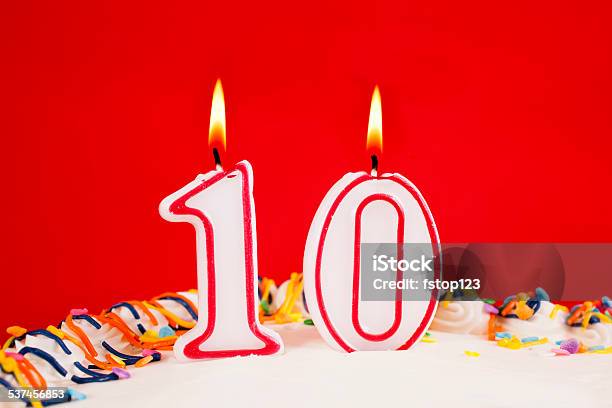 Decorated Birthday Cake With Number 10 Lit Candles Red Background Stock Photo - Download Image Now