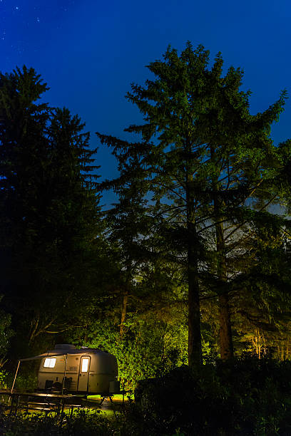 istock Stars shining over illuminated trailer forest campsite Pacific Northwest USA 537457139