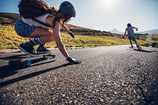 Photo of Young woman skating with her friend