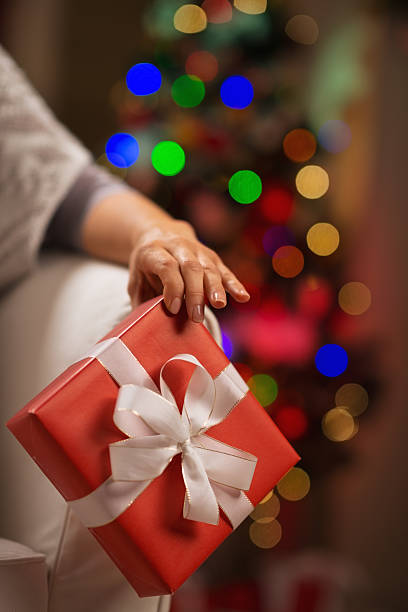 istock closeup on christmas present box in female hand 537458660