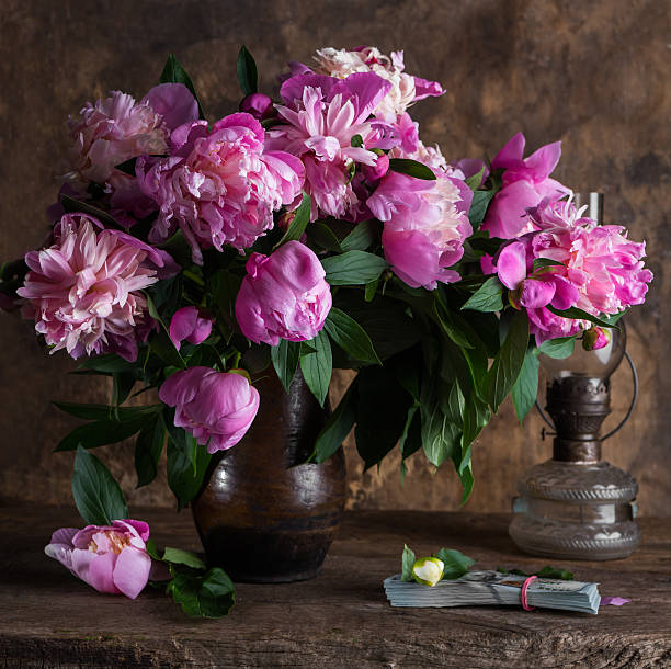 istock Pink peonies and  pack of dollars 537460502