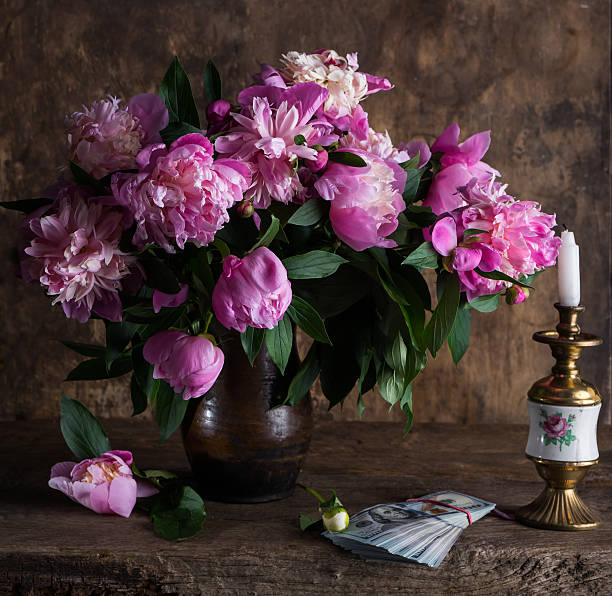istock Pink peonies and  pack of dollars 537460554