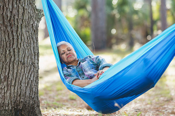 istock Senior black woman sleeping in a hammock 537461624