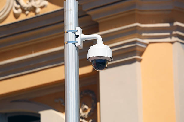 Dome Type Camera in Nice, France Dome Type Outdoor CCTV Camera on Street Lamp in Nice, Architecture of a Church in the Background cityscape videos stock pictures, royalty-free photos & images