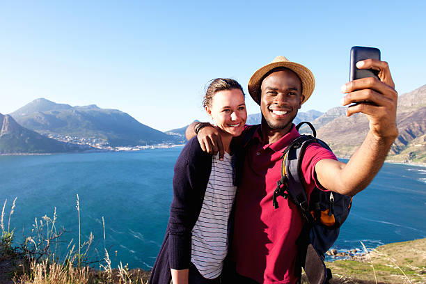 istock Loving young couple on holiday taking selfie 537462742