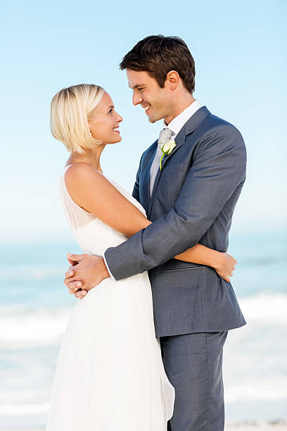 istock Romantic Couple Looking At Each Other On Beach 537464144