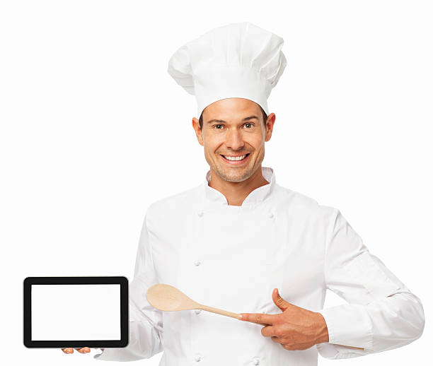 istock Chef With Wooden Spoon Pointing At Digital Tablet 537464714