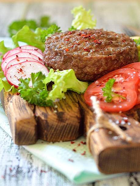 istock Meat grilled burger on a wooden board with vegetables 537466222