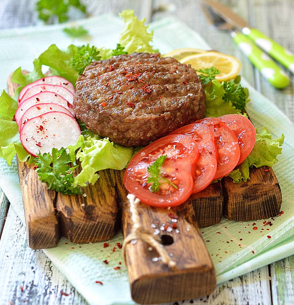 istock Meat grilled burger on a wooden board with vegetables 537466308