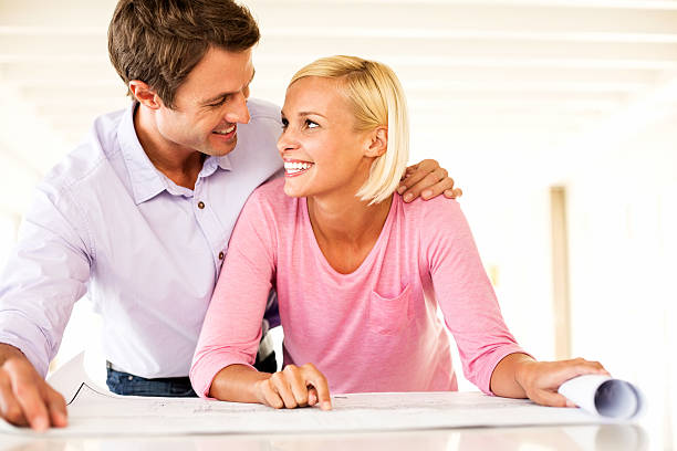 istock Couple With Blueprint Looking At Each Other In House 537467140