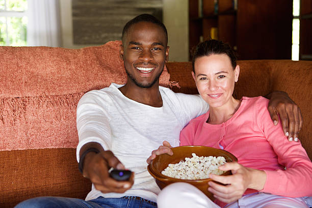 istock Mixed race couple watching a movie at home 537467504