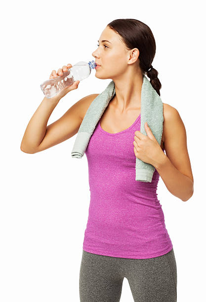 istock Fit Woman With Towel Around Neck Drinking Water From Bottle 537467604
