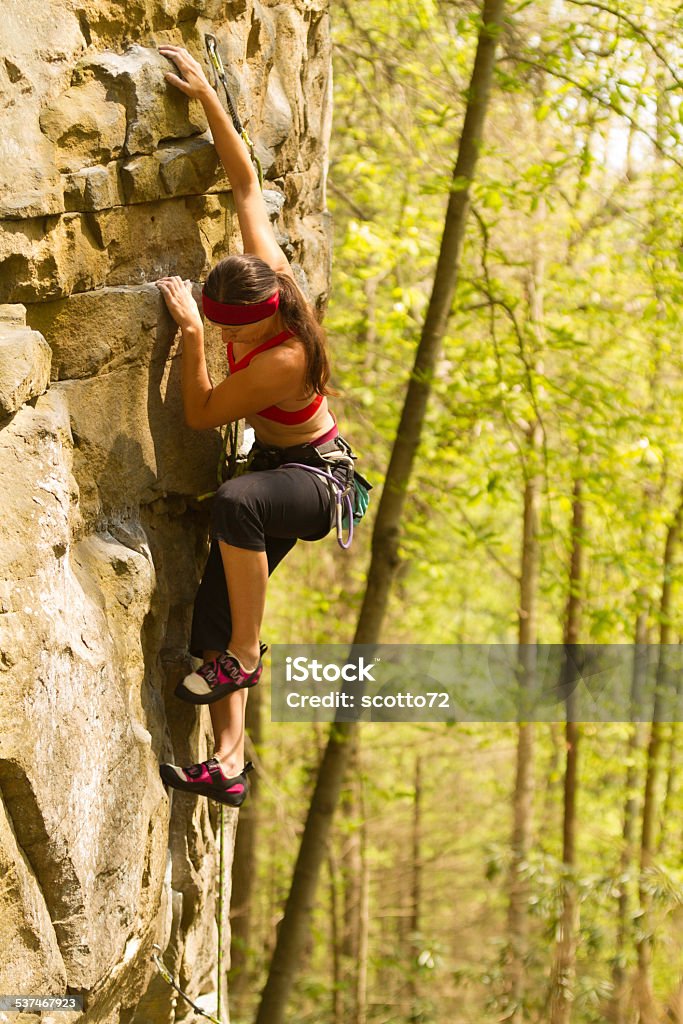 Woman rockclimbing in USA A woman rock climbing, New River Gorge, West Virginia, USA 2015 Stock Photo