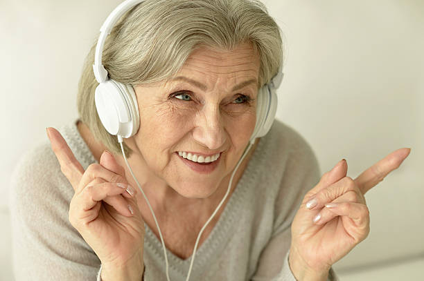istock Senior woman with headphones 537468156