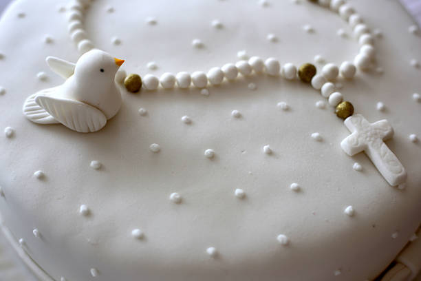Baptism white cake with bird and rosary decoration