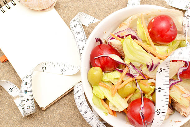 istock salad and tape measure on sand 537468563