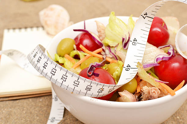 istock salad and tape measure on sand 537468567