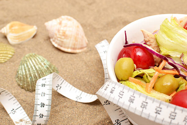istock salad and tape measure on sand 537468571