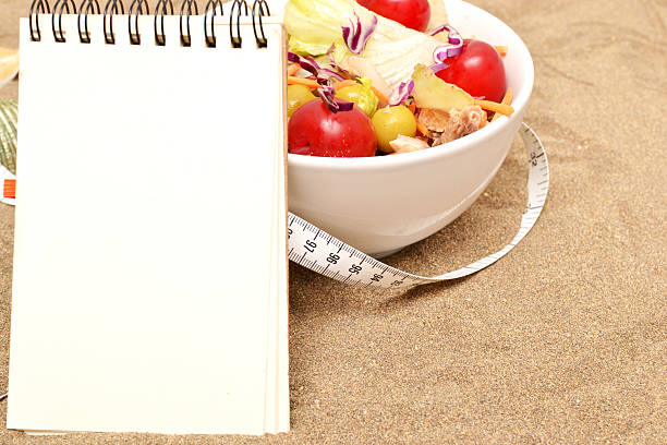 istock salad and tape measure on sand 537468577