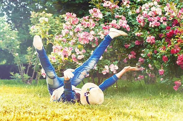 Photo of Happy funny child having fun on the grass. Messing around.