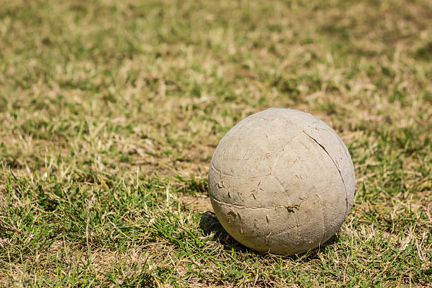 istock old ball on lawn 537468845