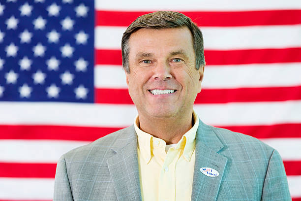 istock Caucasian Man standing in front of American flag 537468972