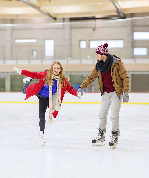 istock happy couple holding hands on skating rink 537469261