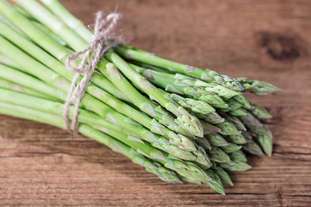istock Bunch of  asparagus on wooden table 537470233