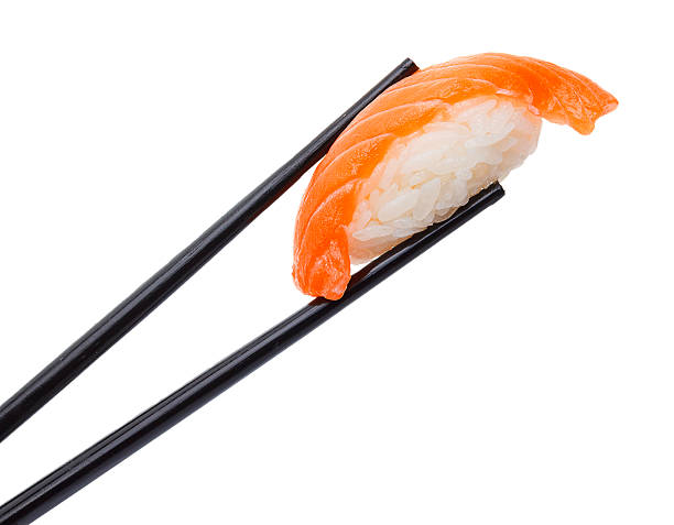 istock Salmon sushi nigiri in chopsticks isolated on white background 537471184