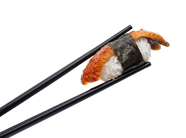 istock Eel sushi nigiri in chopsticks isolated on white background 537471210
