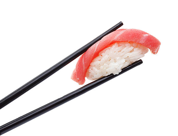 istock Tuna sushi nigiri in chopsticks isolated on white background 537471232