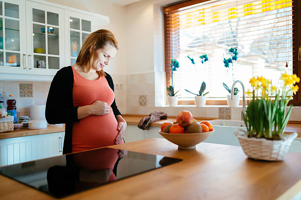 istock Beautiful pregnant woman in kitchen 537471760