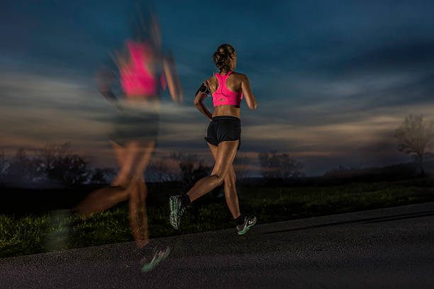 istock Female runner on the road in the evening 537476778