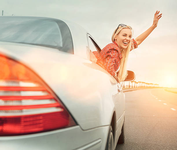 istock Beautiful smiling lady look out from car window 537477804
