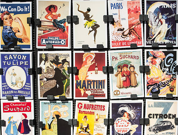 Vintage Posters and Advertisements for Sale at Traditional Bookstall, Paris Paris, France - April 27, 2016: Vintage posters and advertisements for sale by bookinist (Le Bouquinist) at a traditional bookstall near Seine River. The Bouquinistes sell their used and antiquarian books along the banks of the Seine allready for centuries.  poster photos stock pictures, royalty-free photos & images