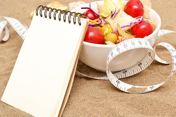 istock salad and tape measure on sand 537484565