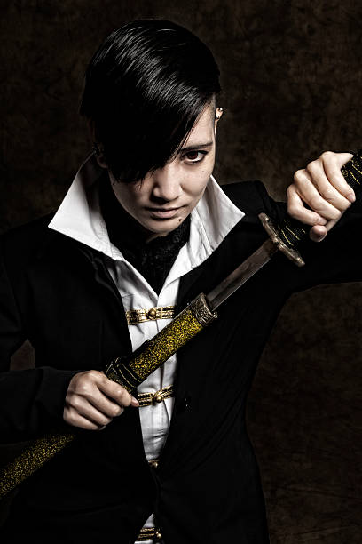 istock Gritty image of young Asian man drawing katana diagonally. 537486533