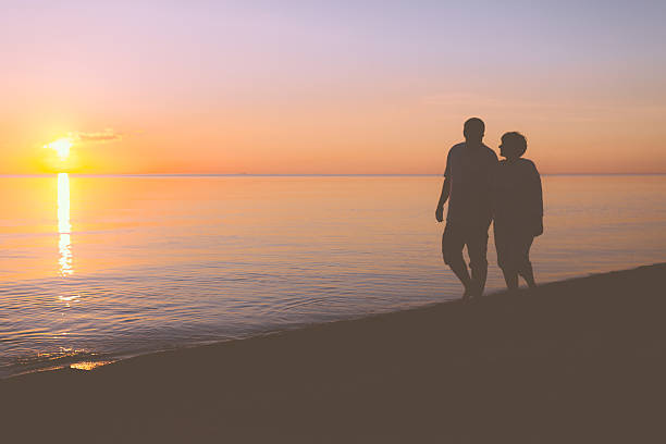 istock Senior couple walking along the beach 537488705