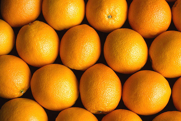 istock Many ripe oranges as background over black coseup 537489481