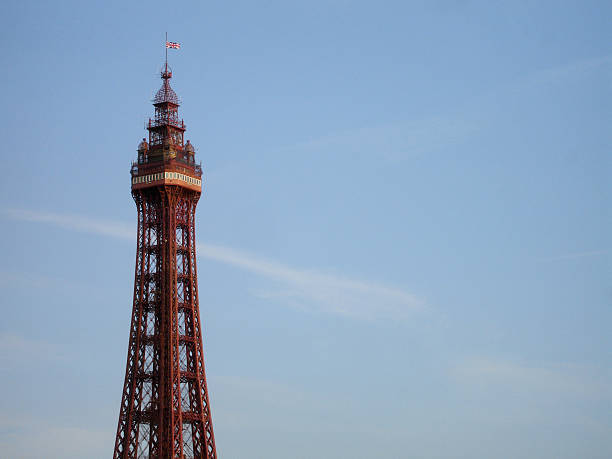 Blackpool Tower against blue sky Iconic Blackpool Tower against summer blue sky with few wispy clouds Blackpool Tower stock pictures, royalty-free photos & images