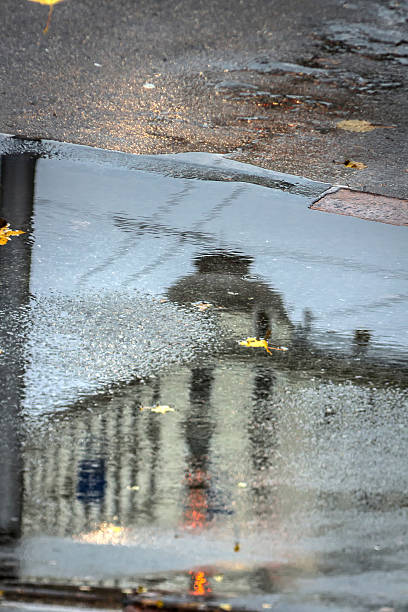 istock Building is reflected in a pool of rainwater in Riga 537490811