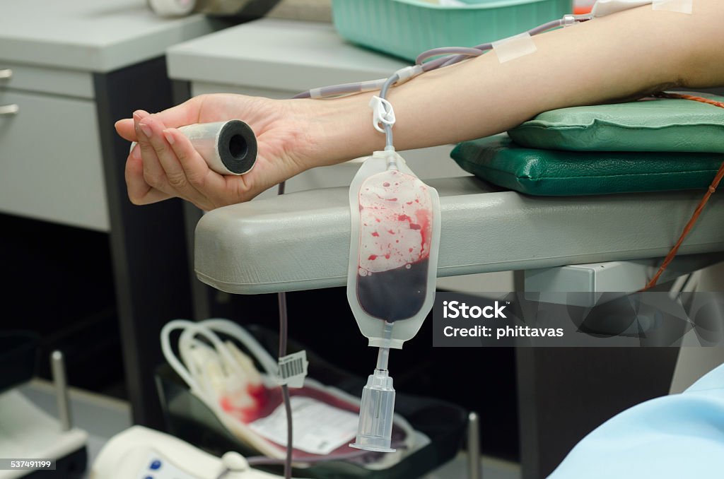 Blood donor at donation Blood donor at donation with a bouncy ball holding in hand 2015 Stock Photo