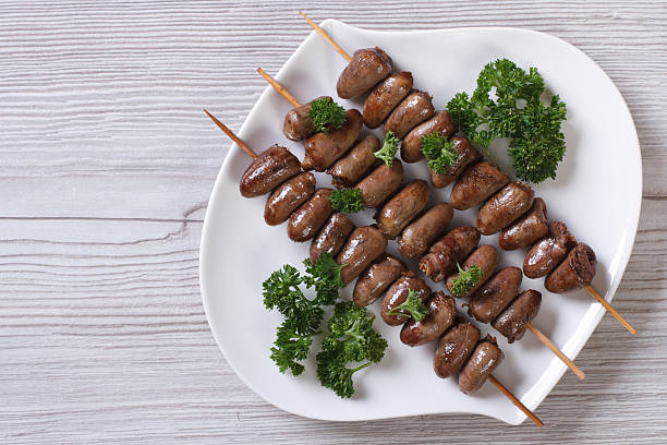 Chicken hearts grilled on skewers. top view Chicken hearts grilled on skewers. top view of the horizontal animal internal organ photos stock pictures, royalty-free photos & images