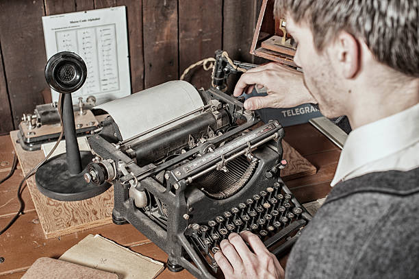 istock Male Typist on an Antique Typewriter in a Telegraph Office. 537498027
