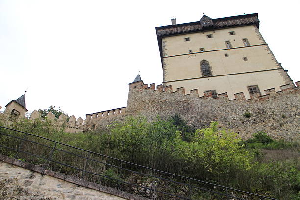 Karlstejn, Czech Republic - August 12, 2014: Karlstejn Castle (Burg Karlstein) is a large Gothic castle founded 1348 AD by Charles IV, Holy Roman Emperor-elect and King of Bohemia. The castle served as a place for safekeeping the Imperial Regalia as well as the Bohemian/Czech crown jewels, holy relics, and other royal treasures. Located about 30 km southwest of Prague above the village of the same name, it is one of the most famous and most frequently visited castles in the Czech Republic.